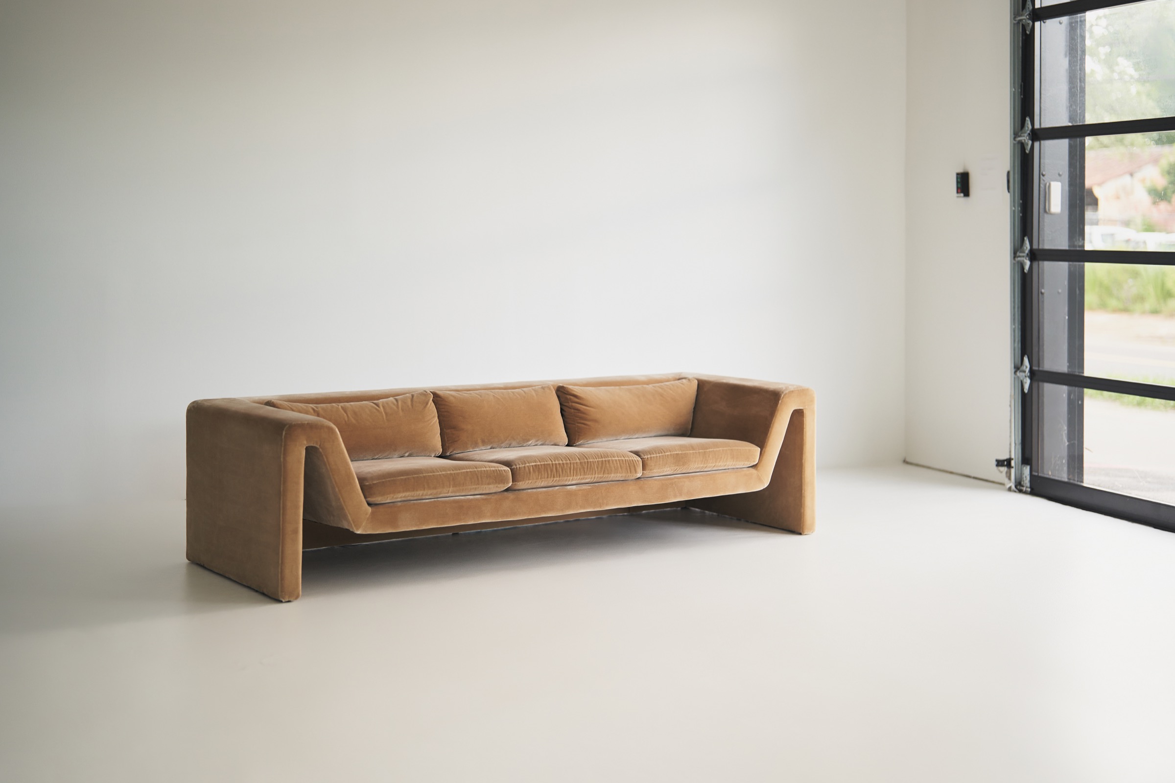 35MM Studio rental space with a sculptural sofa beside the garage door