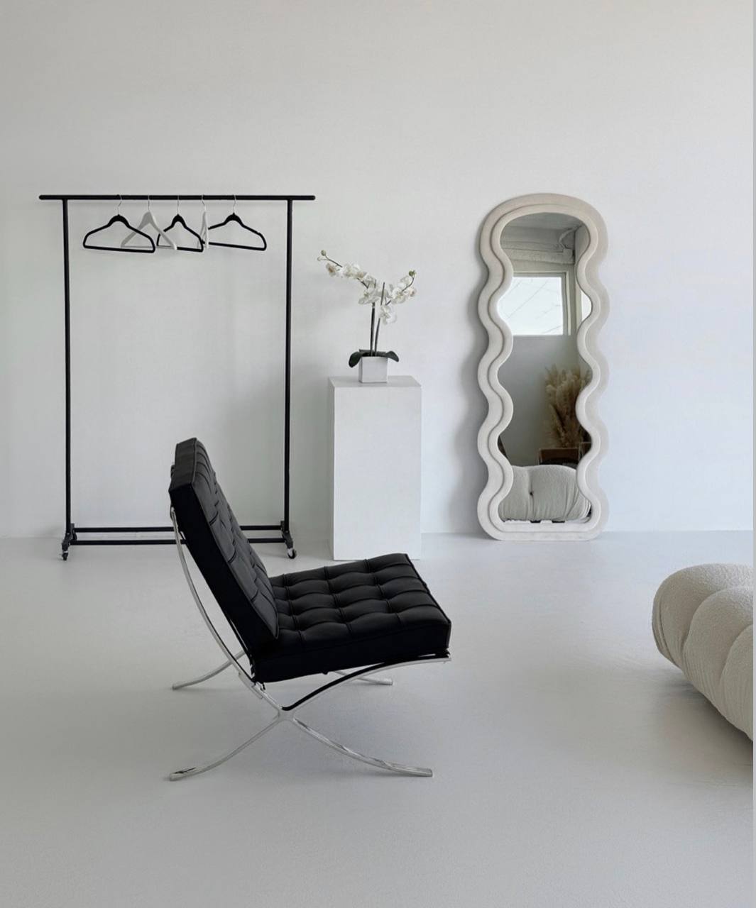 Cream modular sofa and sculptural mirror inside the studio